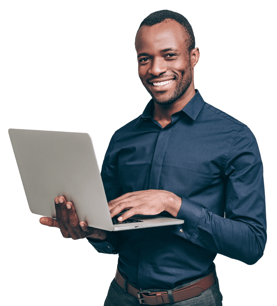 Photograph of man standing with laptop smiling at camera