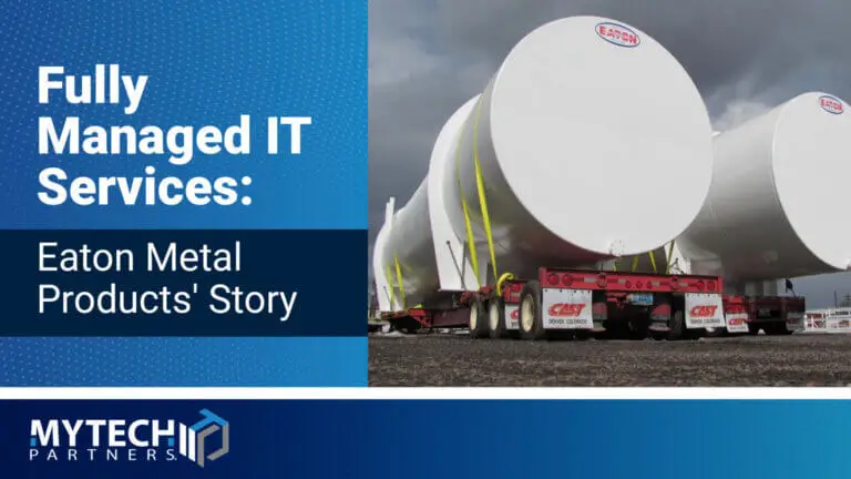 Large white steel storage tanks manufactured by Eaton Metal Products secured on transport trailers at a Denver, Colorado industrial yard.