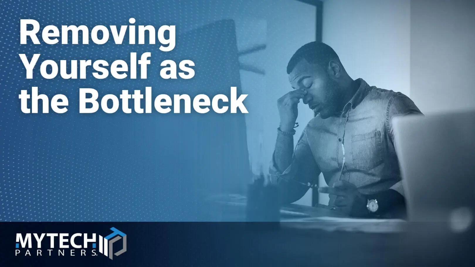Featured image showing a professional working at a desk with text about removing organizational bottlenecks.